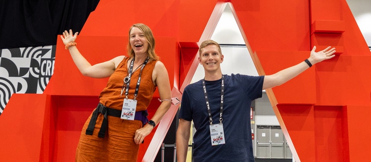 Photo of two adobe max workers